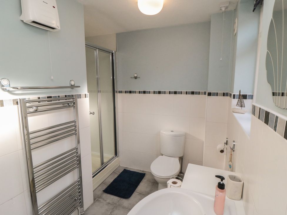 A bathroom with a shower and sink at Bramla in Staithes