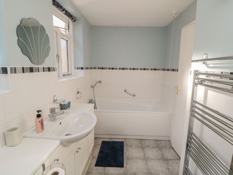 A bathroom with a sink and bathtub at Bramla in Staithes