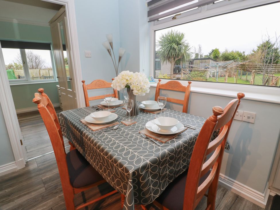 A dining room with a table set for four at Mardan in Southerness