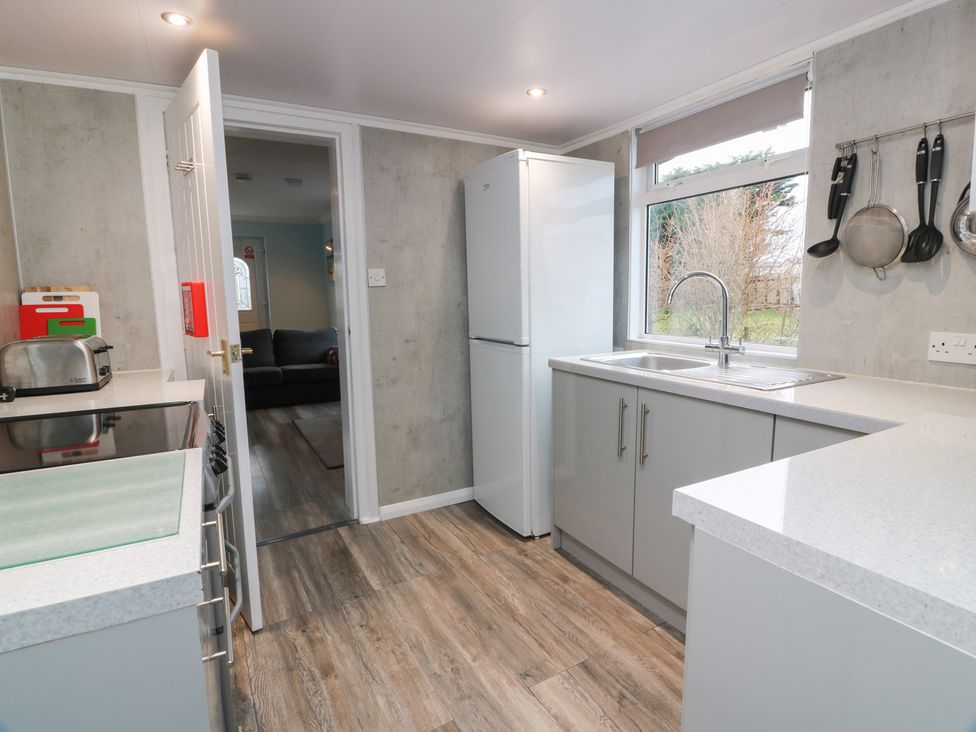 A kitchen with a refrigerator and sink at Mardan in Southerness