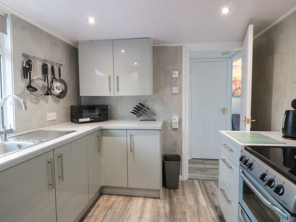 A kitchen with cabinets and appliances at Mardan in Southerness