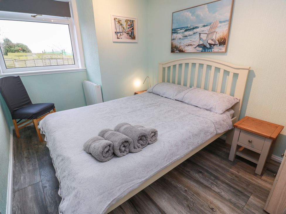 A bedroom with a bed and a chair at Mardan in Southerness