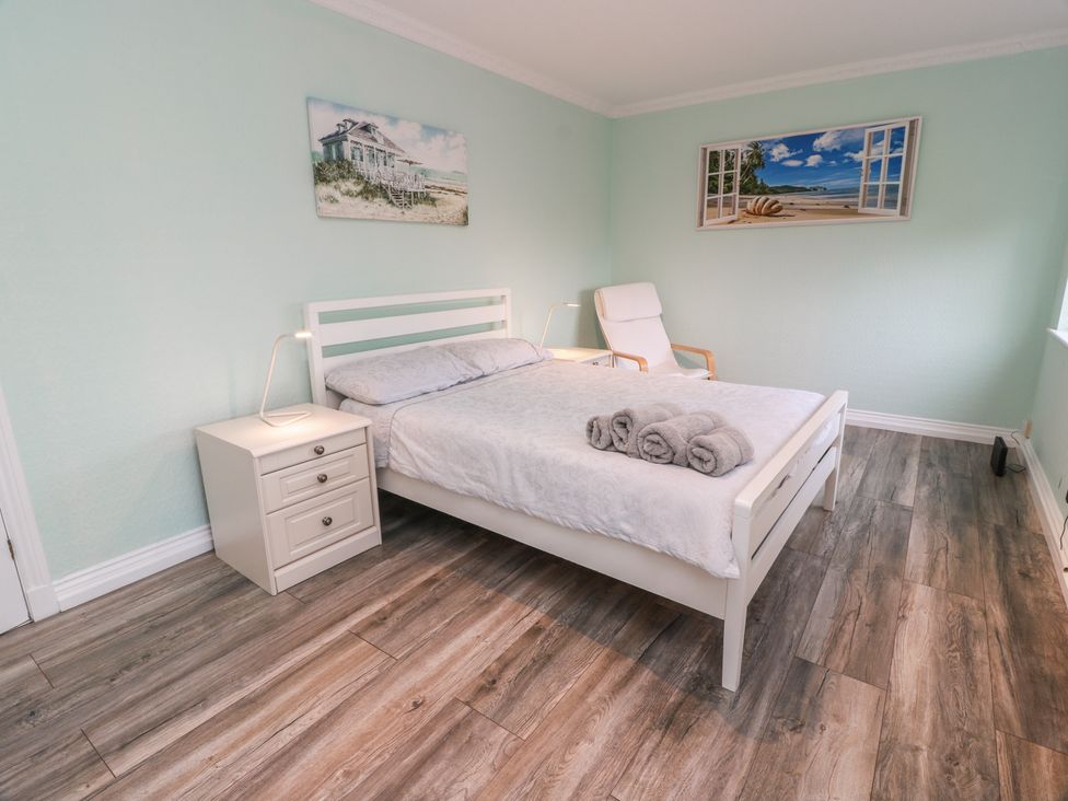 A bedroom with a bed and nightstand at Mardan in Southerness
