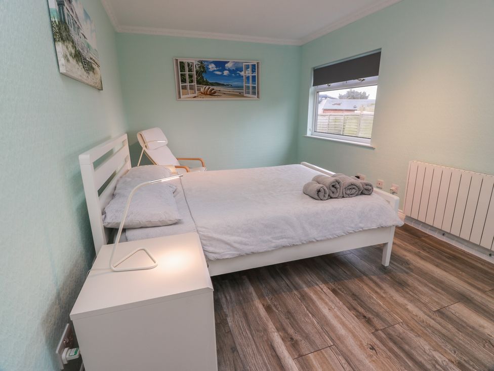 A bedroom with a bed and nightstand at Mardan in Southerness