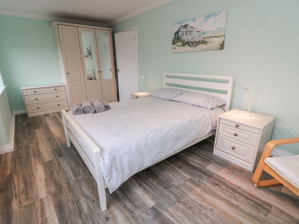 A bedroom with a bed and wardrobe at Mardan in Southerness