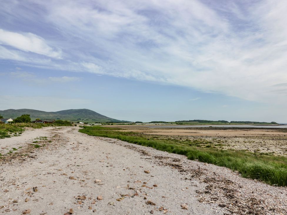 A beach path with mountains in the background at Mardan in Southerness