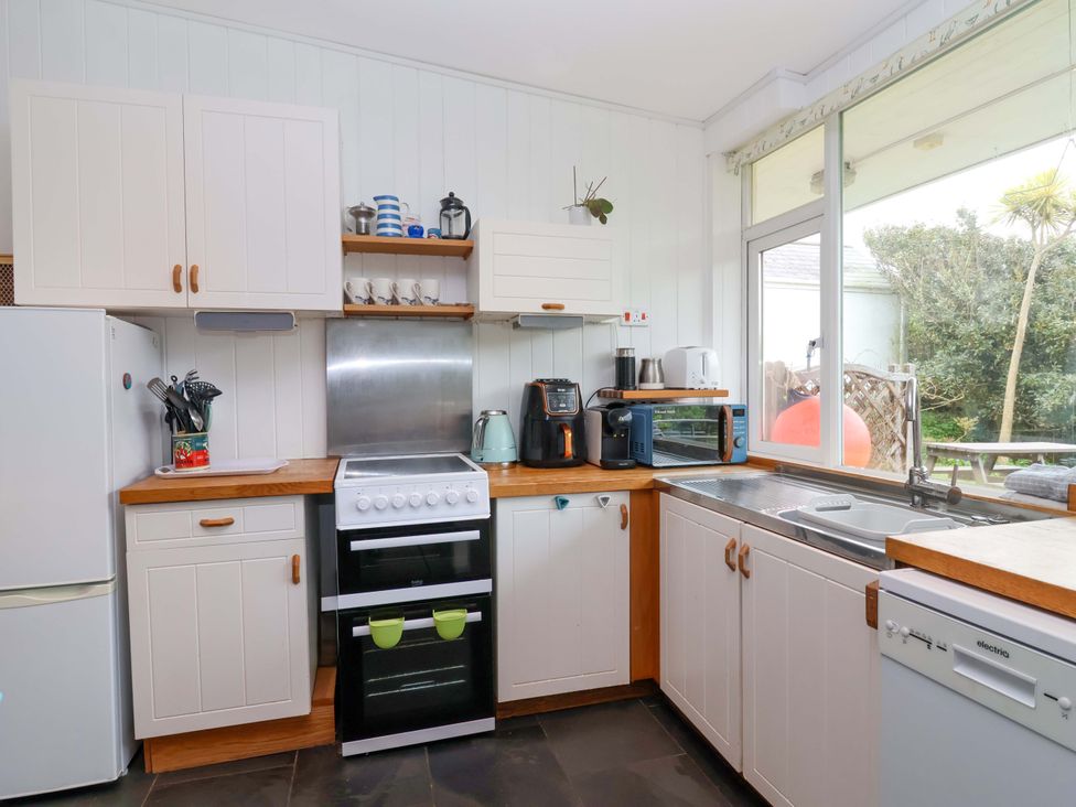 A kitchen with appliances and a sink at 2 Brook Cottages in Hope Cove