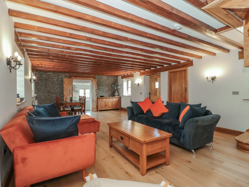 A living room with a coffee table and sofas at Penrhiwarwydd Barn in Pontywaun