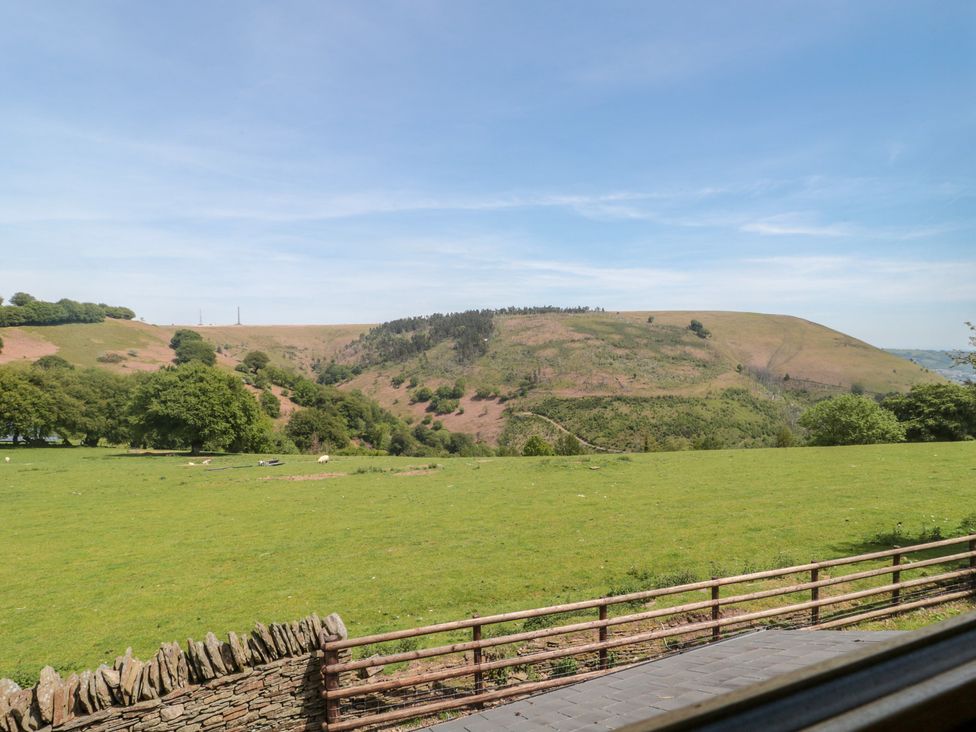 A view of hills and fields at Penrhiwarwydd Barn in Pontywaun