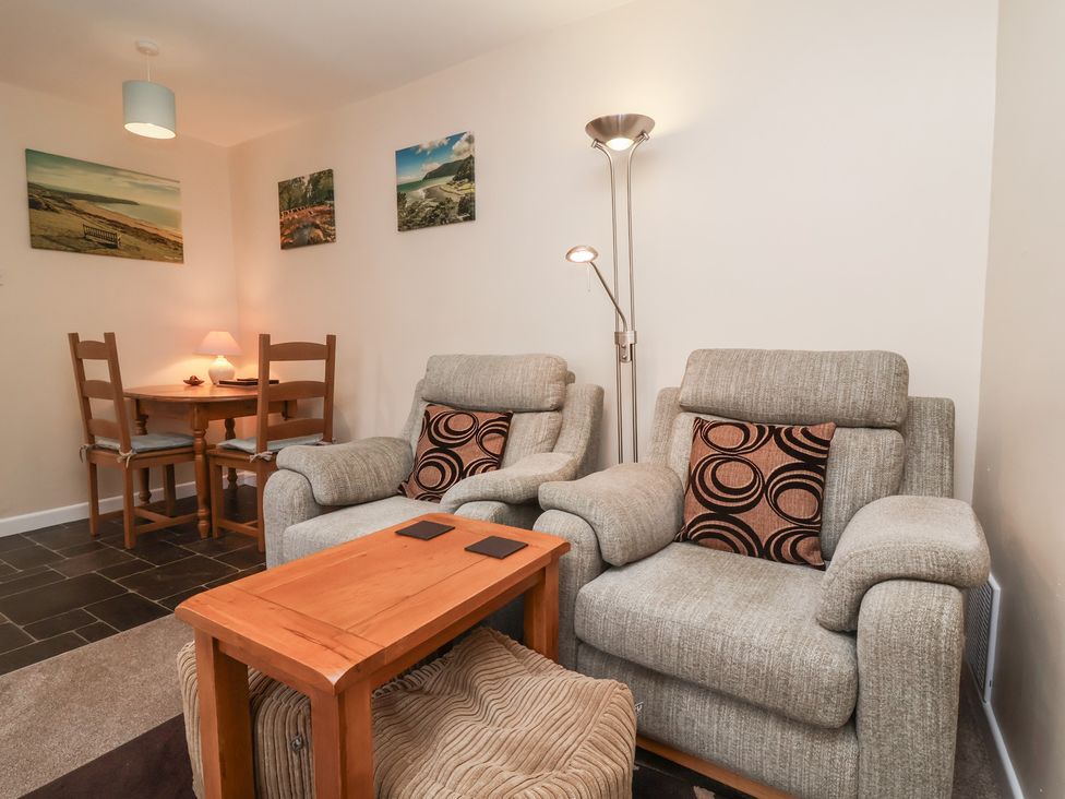 A living room with a sofa and dining table at Enginefield in Combe Martin