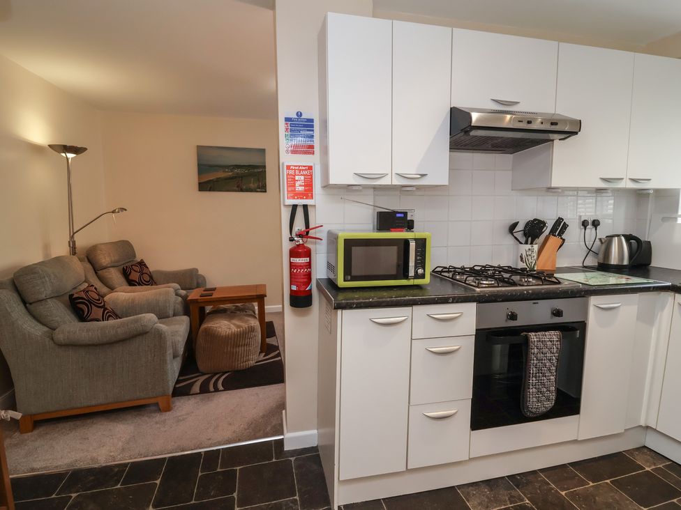 A kitchen with sofa and coffee table at Enginefield in Combe Martin