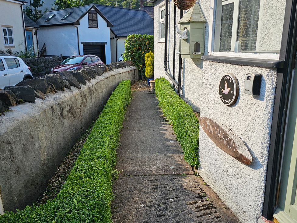 A pathway leading to the entrance of Dove Cottage in Llanfair Talhaiarn