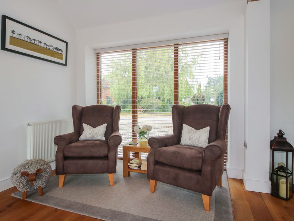 A living room with two chairs and a table at Meeson View in Meeson near Waters Upton