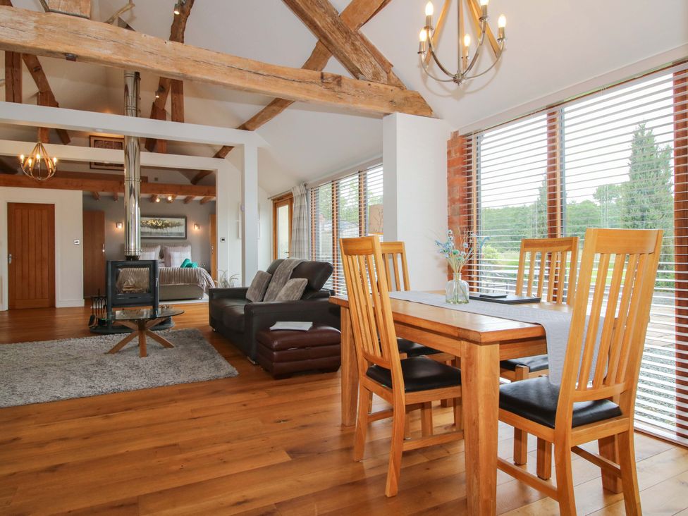 A living room with a sofa and dining table at Meeson View in Meeson near Waters Upton