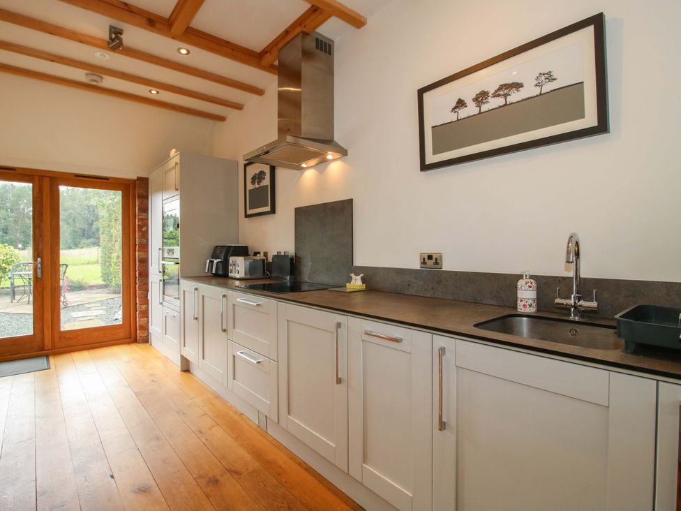 A kitchen with cabinets and a sink at Meeson View in Meeson near Waters Upton