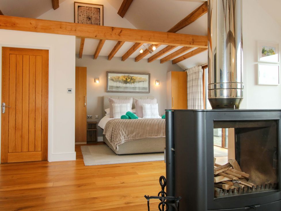 A bedroom with a bed and fireplace at Meeson View in Meeson near Waters Upton