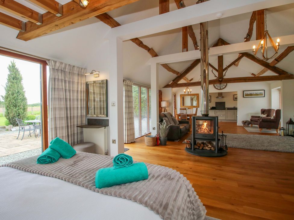 A living room with a fireplace and seating area at Meeson View near Waters Upton