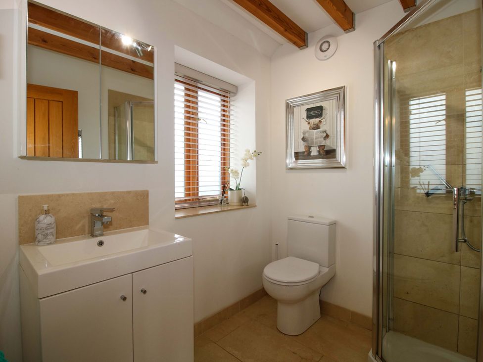 A bathroom with a sink, toilet, and shower at Meeson View near Waters Upton