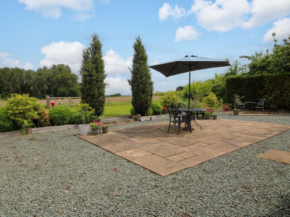 A garden with seating area and plants at Meeson View, Meeson near Waters Upton