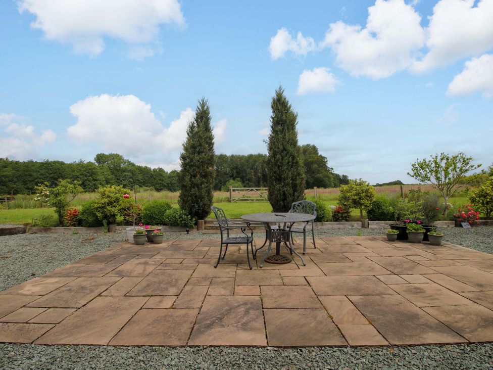 A patio with a table and chairs at Meeson View in Meeson near Waters Upton