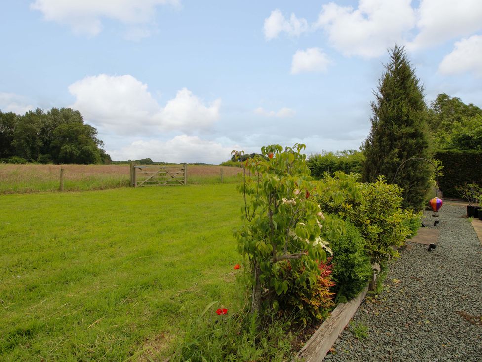 A garden with grass and a gate at Meeson View in Meeson near Waters Upton