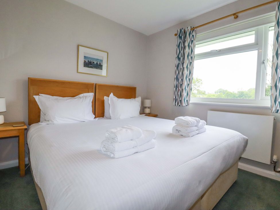 A bedroom with a double bed and nightstand at The Meadow in Feock near Carnon Downs