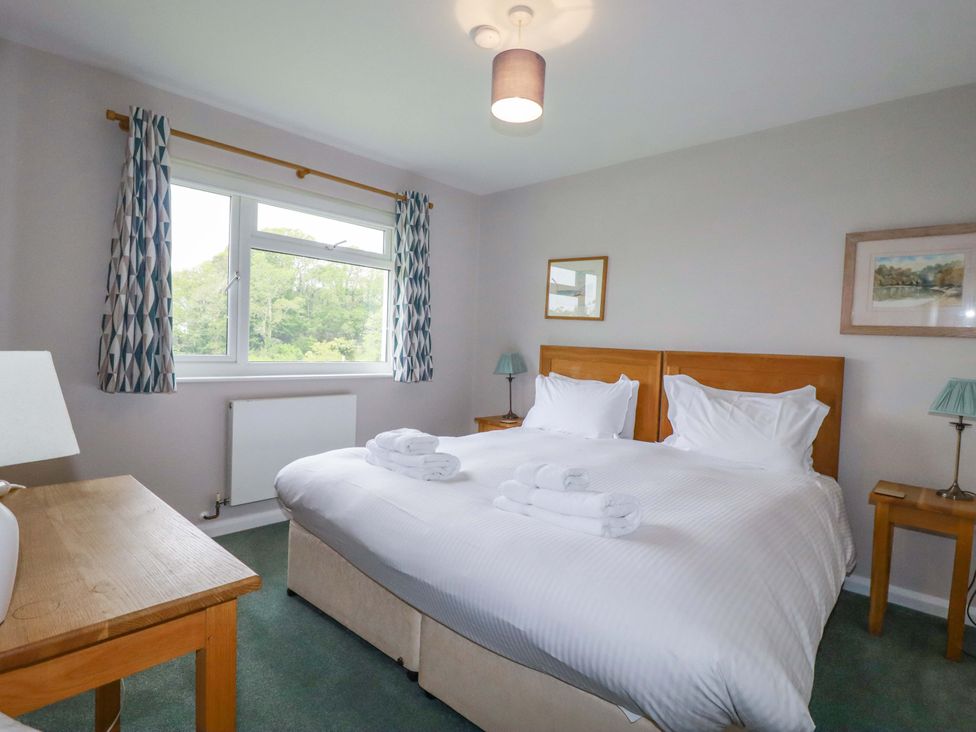 A bedroom with two beds and a window at The Meadow in Feock near Carnon Downs