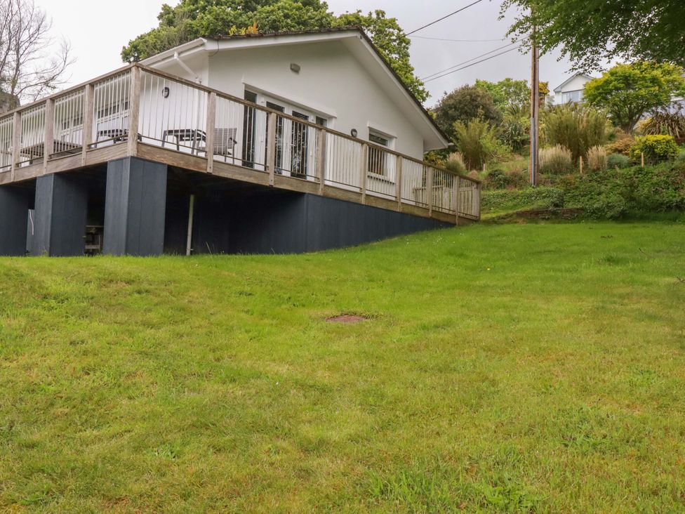 A house with a deck and grass area at The Meadow in Feock near Carnon Downs