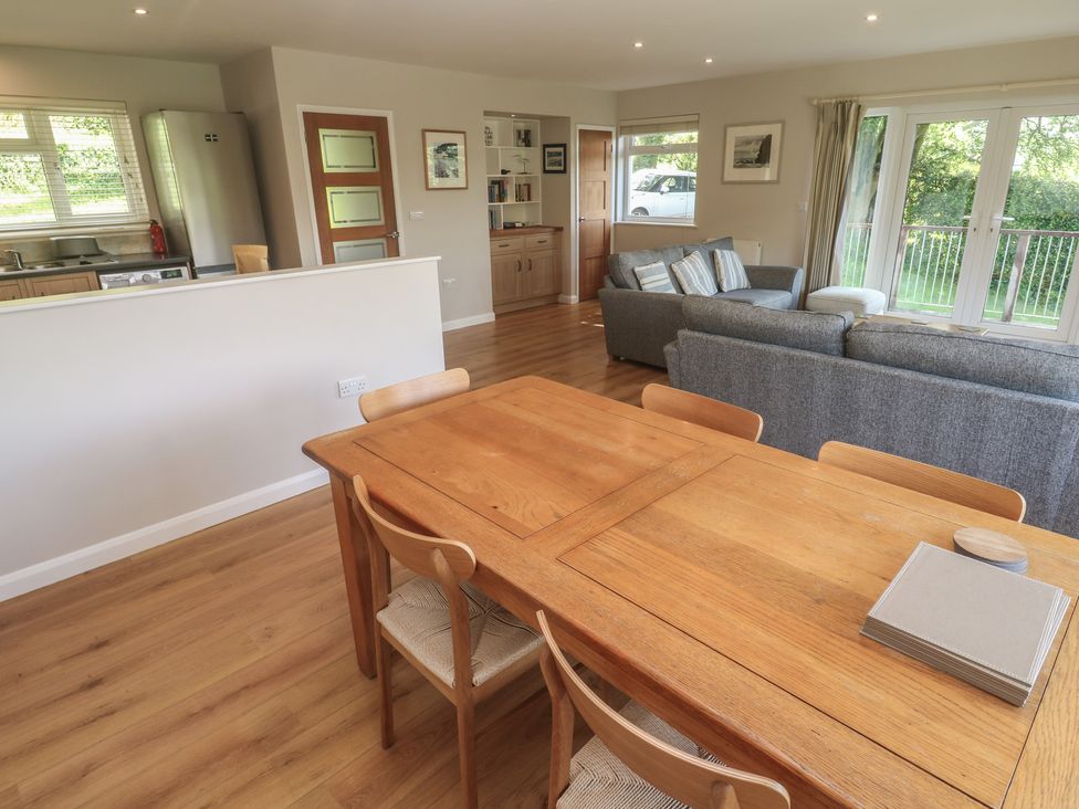 A dining room with a wooden table and chairs at The Meadow in Feock near Carnon Downs