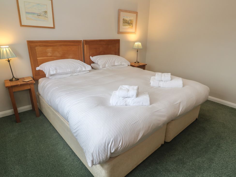 A bedroom with a double bed and bedside tables at The Meadow in Feock near Carnon Downs