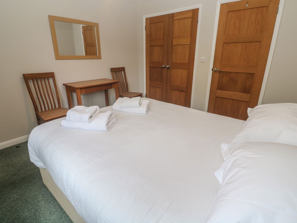 A bedroom with a bed and a small table with chairs at The Meadow in Feock near Carnon Downs