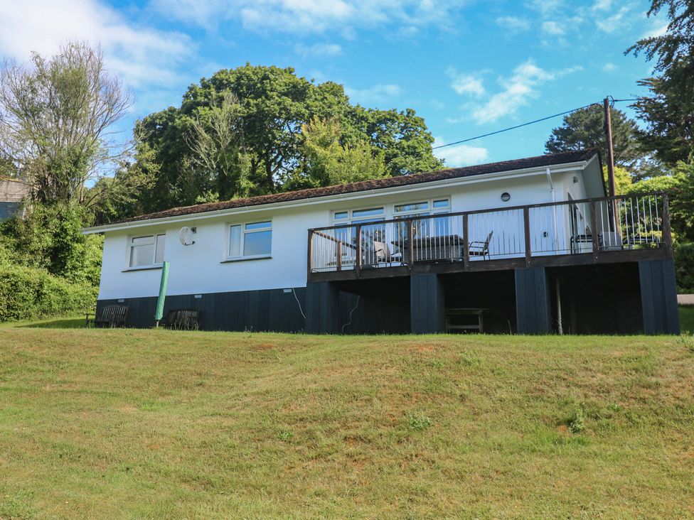A house with a deck and chairs at The Meadow in Feock near Carnon Downs