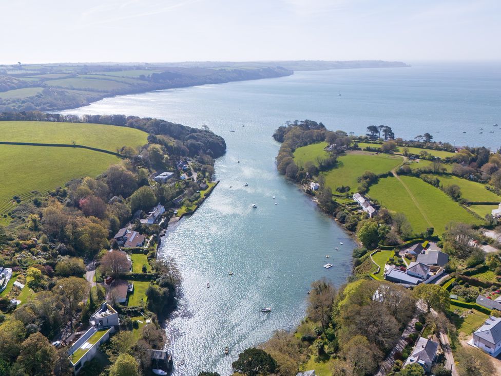An aerial view of a river with boats and surrounding greenery at The Meadow in Feock near Carnon Downs