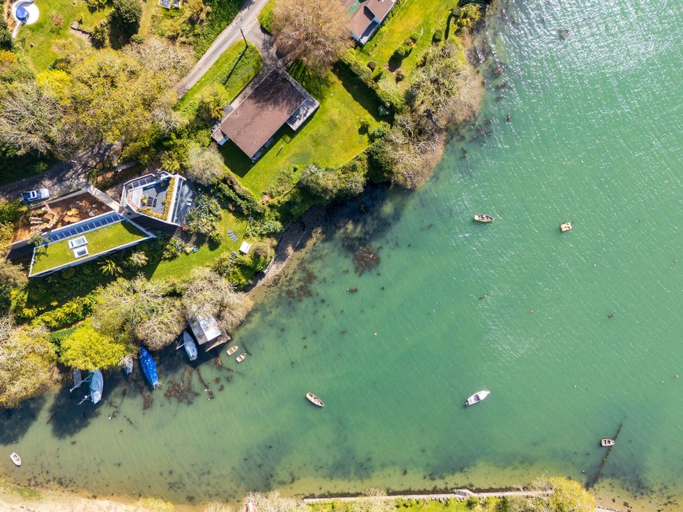 An aerial view of houses and boats near a body of water at The Meadow in Feock near Carnon Downs