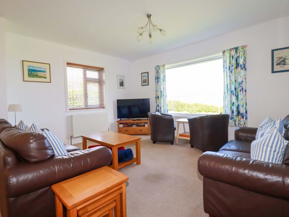 A living room with a television and sofa at Pentreath in Crantock