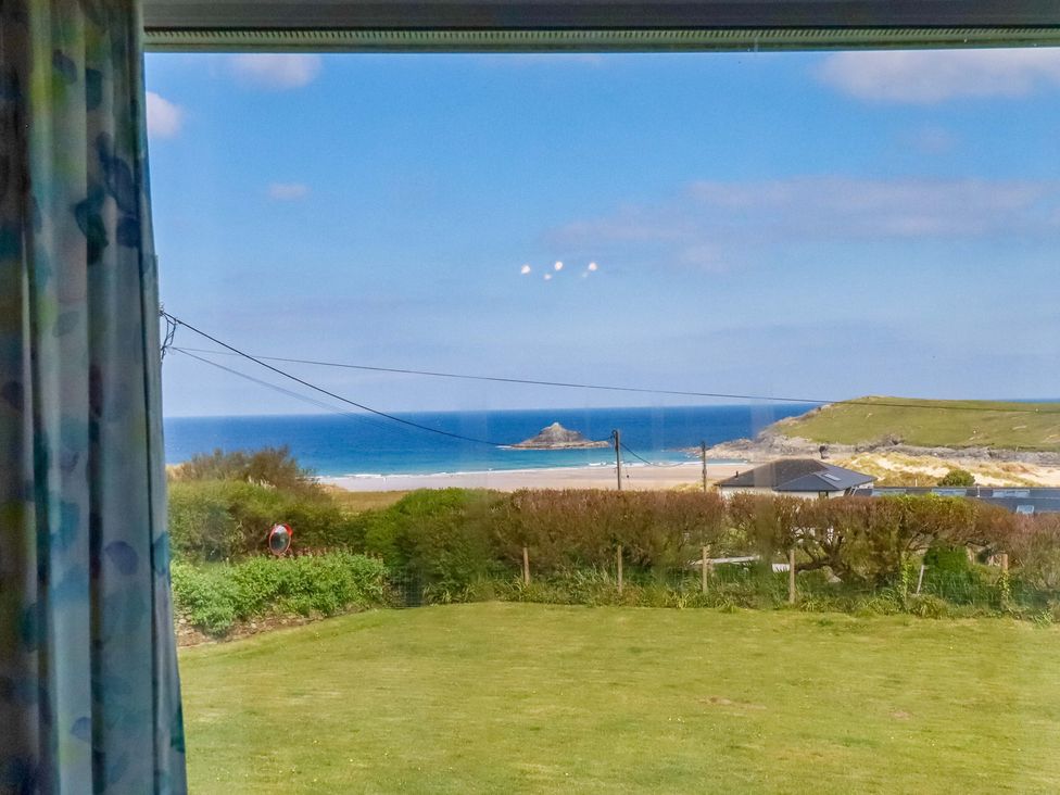A view of the ocean and beach from a window at Pentreath in Crantock