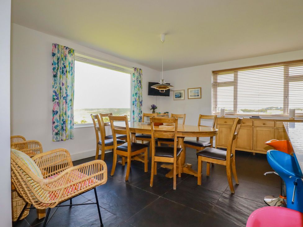 A dining room with a table and chairs at Pentreath in Crantock