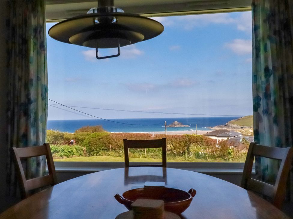 A dining room with a view of the sea at Pentreath in Crantock