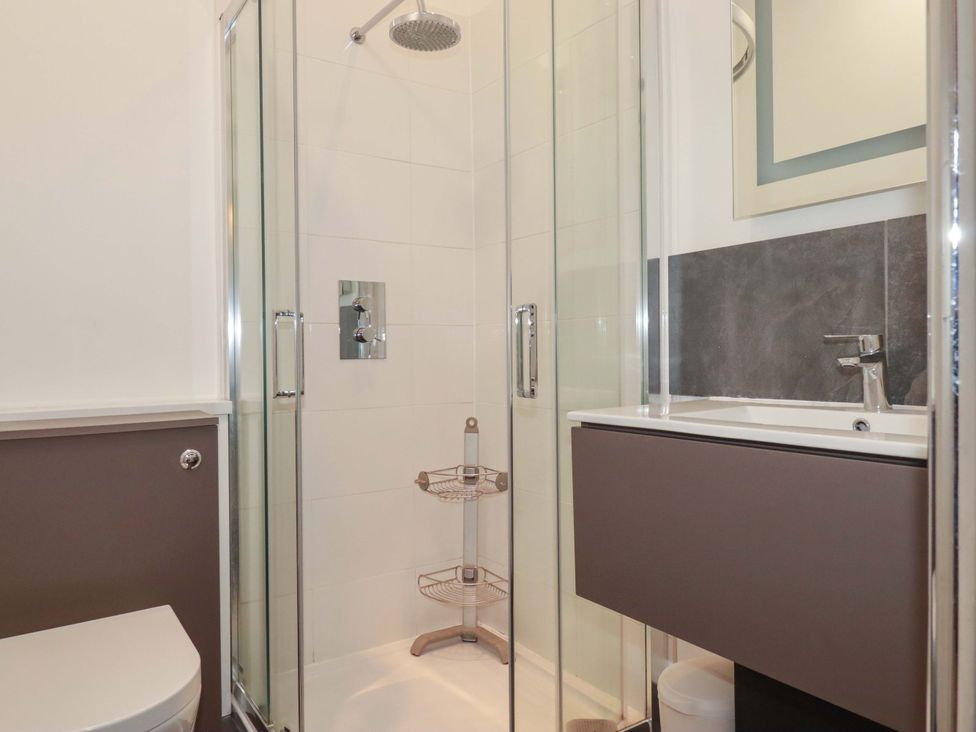 A bathroom with a shower and toilet at Pentreath in Crantock