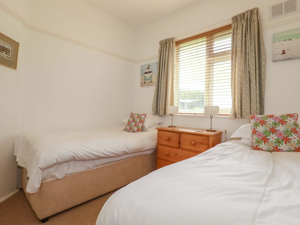 A bedroom with two beds and a chest of drawers at Pentreath in Crantock