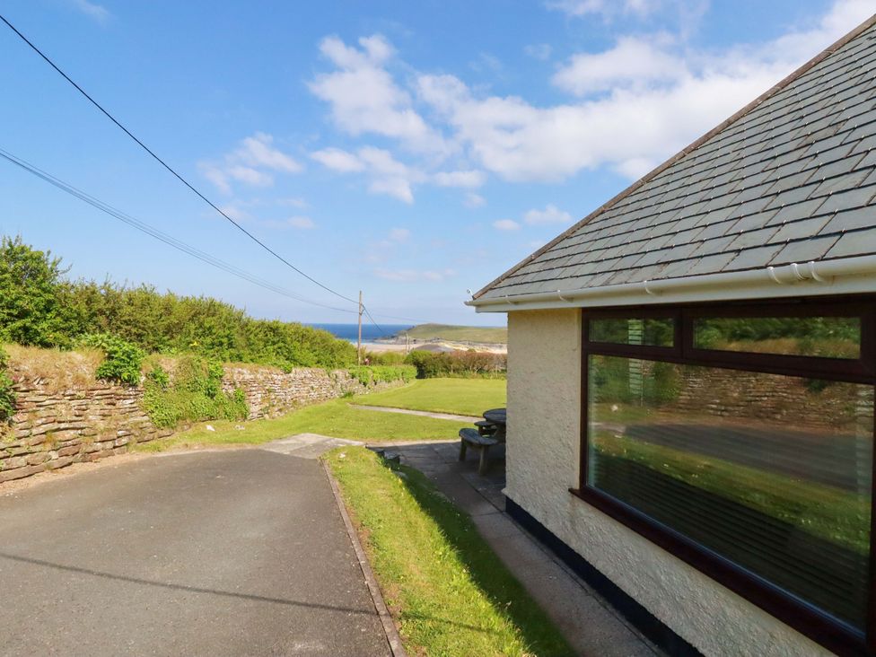 A house with a garden and road leading towards the sea at Pentreath in Crantock