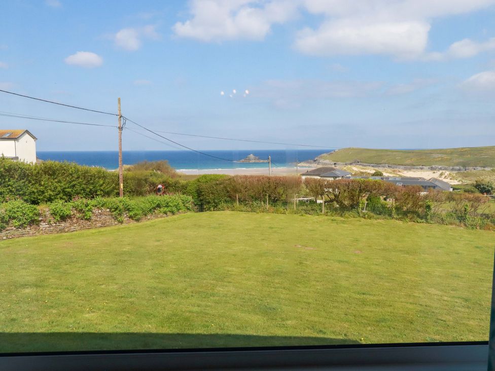 A view of the sea and beach from a grassy area at Pentreath in Crantock