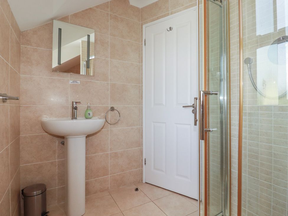 A bathroom with a sink and shower at Carpe Diem in Crantock
