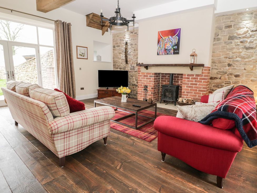 A living room with sofas and a coffee table at The Turnip Barn in 