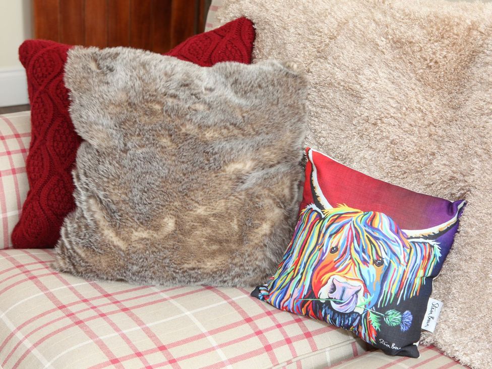 A living room with cushions on a sofa at The Turnip Barn