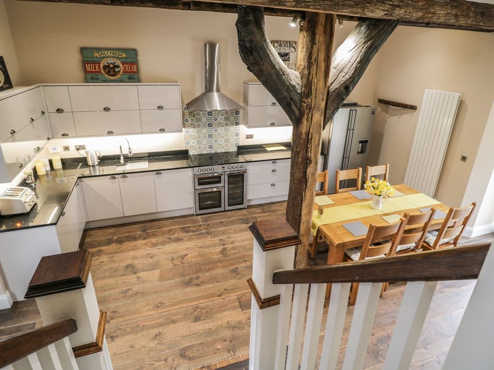 A kitchen with a dining table and chairs at The Turnip Barn in 