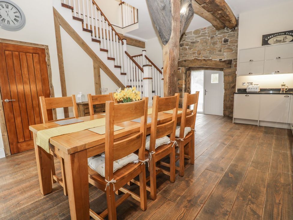 A dining room with a table and chairs at The Turnip Barn