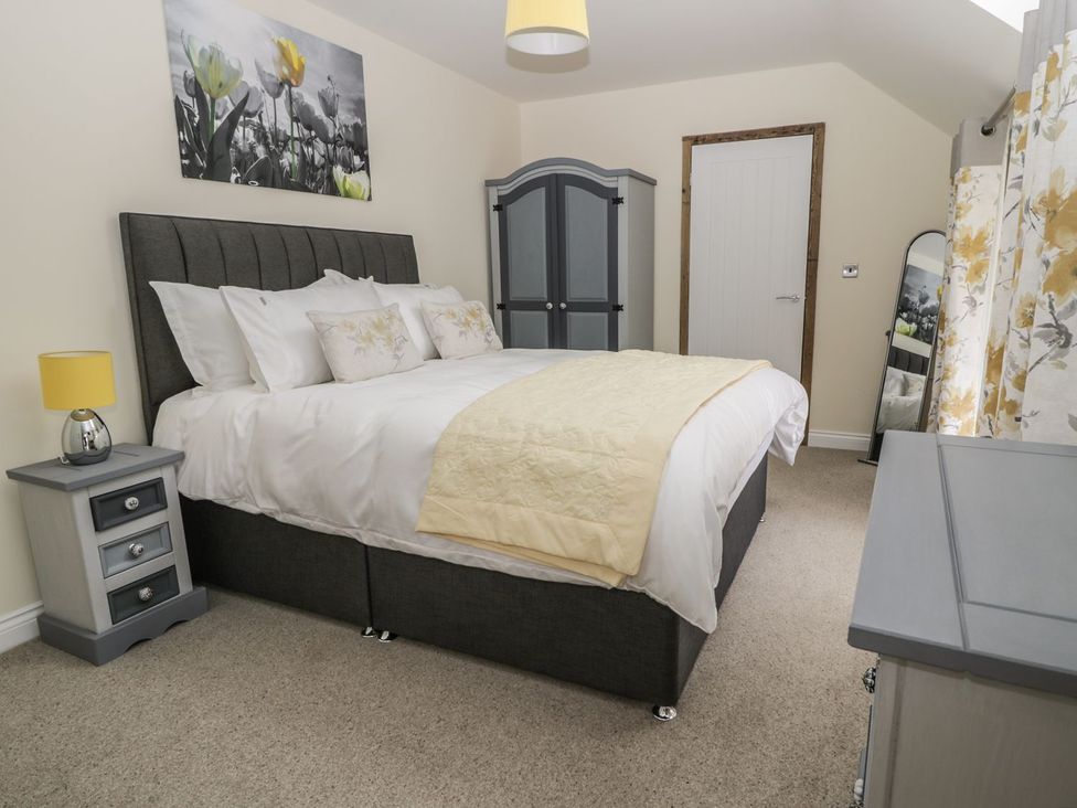 A bedroom with a bed and a wardrobe at The Turnip Barn in 