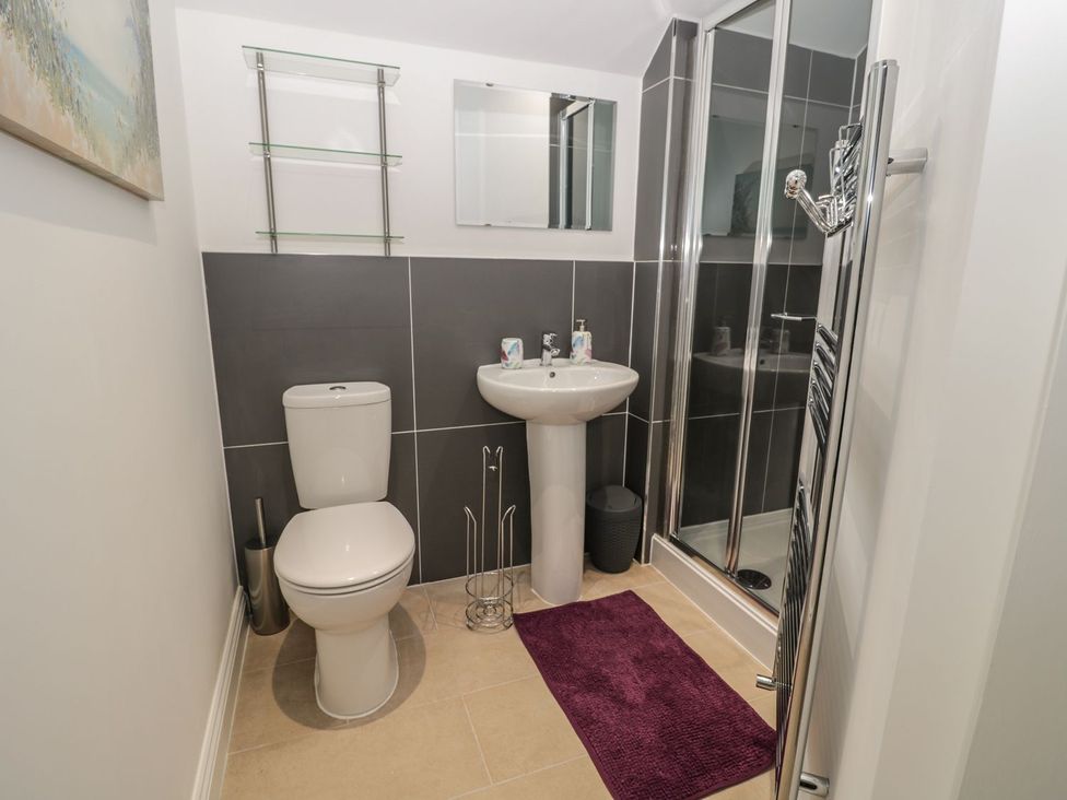 A bathroom with a toilet, sink, and shower at The Turnip Barn in 