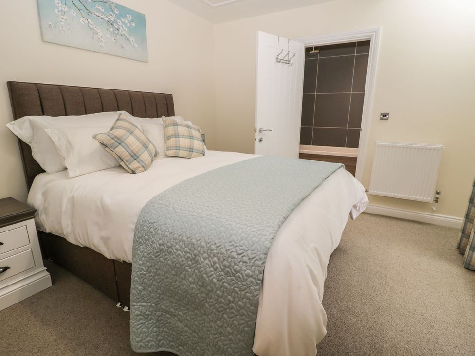 A bedroom with a bed and wall art at The Turnip Barn in 